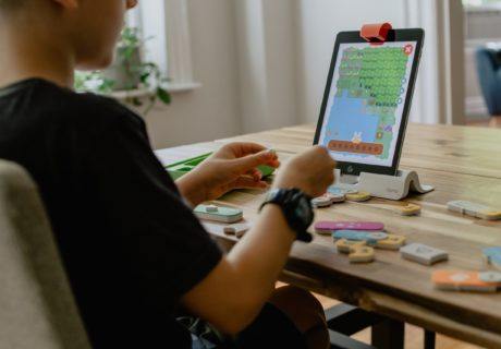 Young man coding using manipulatives learn math through coding