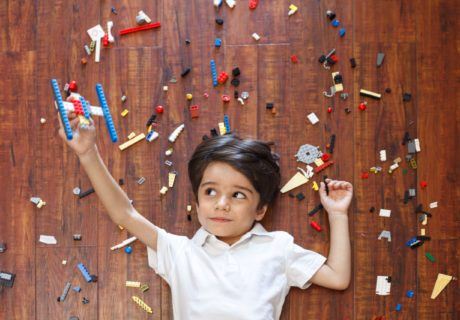 Young Boy Surrounded by Legos