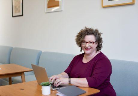 Computer Science Curriculum CoderZ Robotics Woman Sitting at Table working on laptop